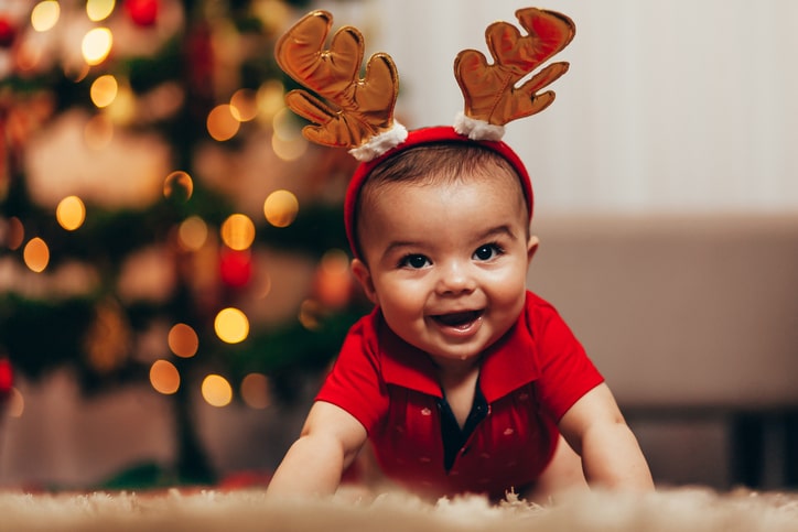 baby wearing reindeer antlers