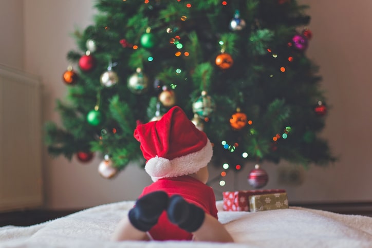 baby in front of a christmas tree